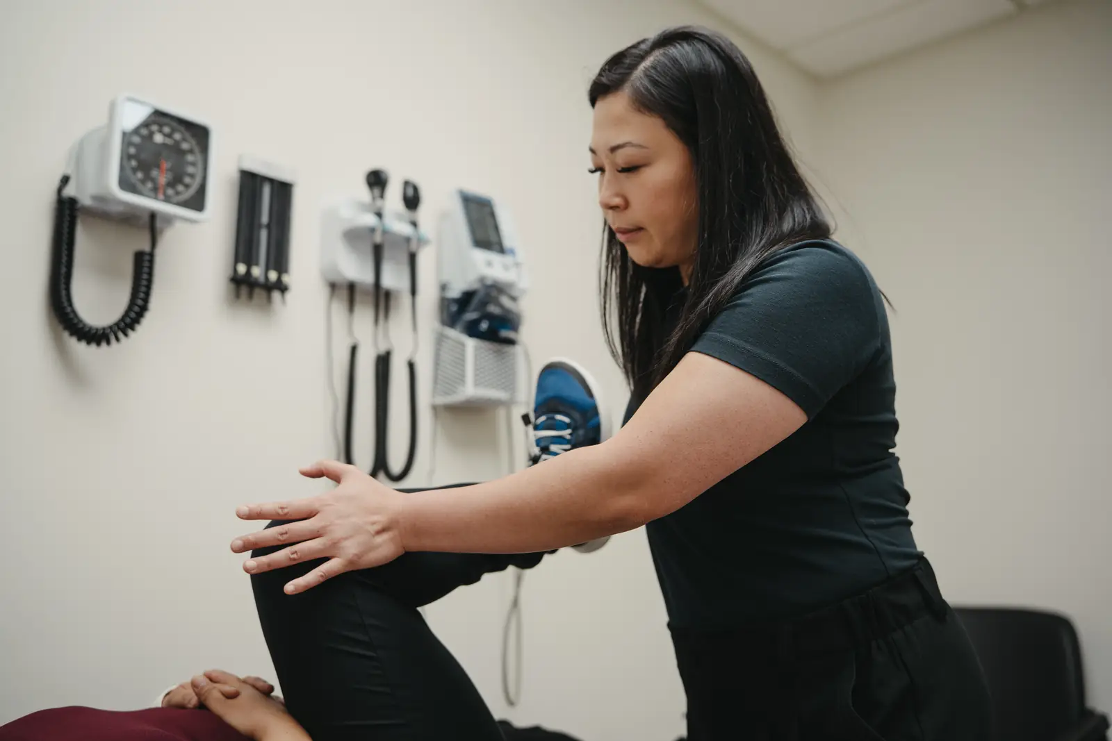 Physiotherapist An Luu working on a patient's leg in a McCallum Road treatment room