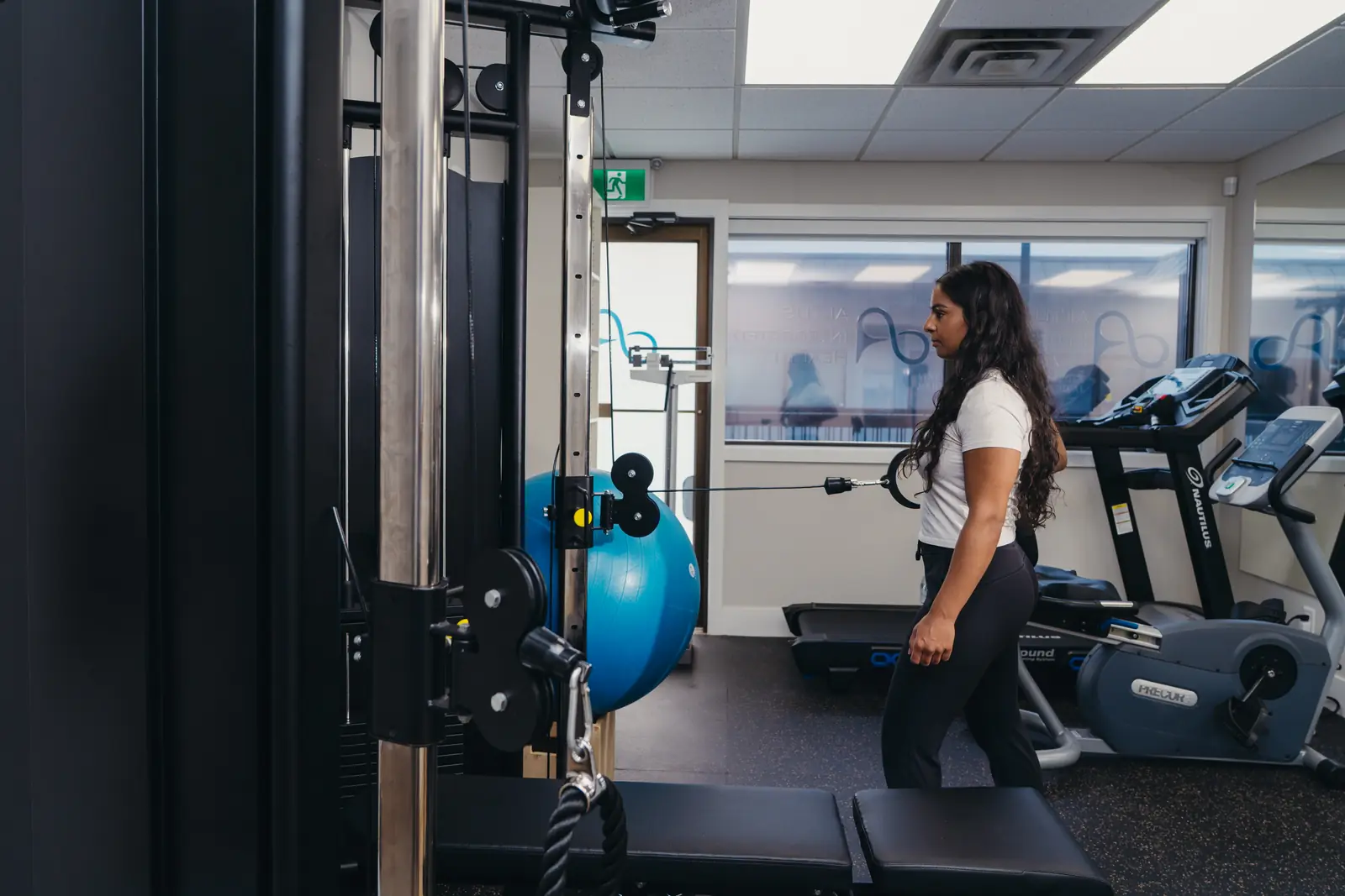 Physiotherapist Nikkie Brar using the cable machine in the McCallum Road rehab gym