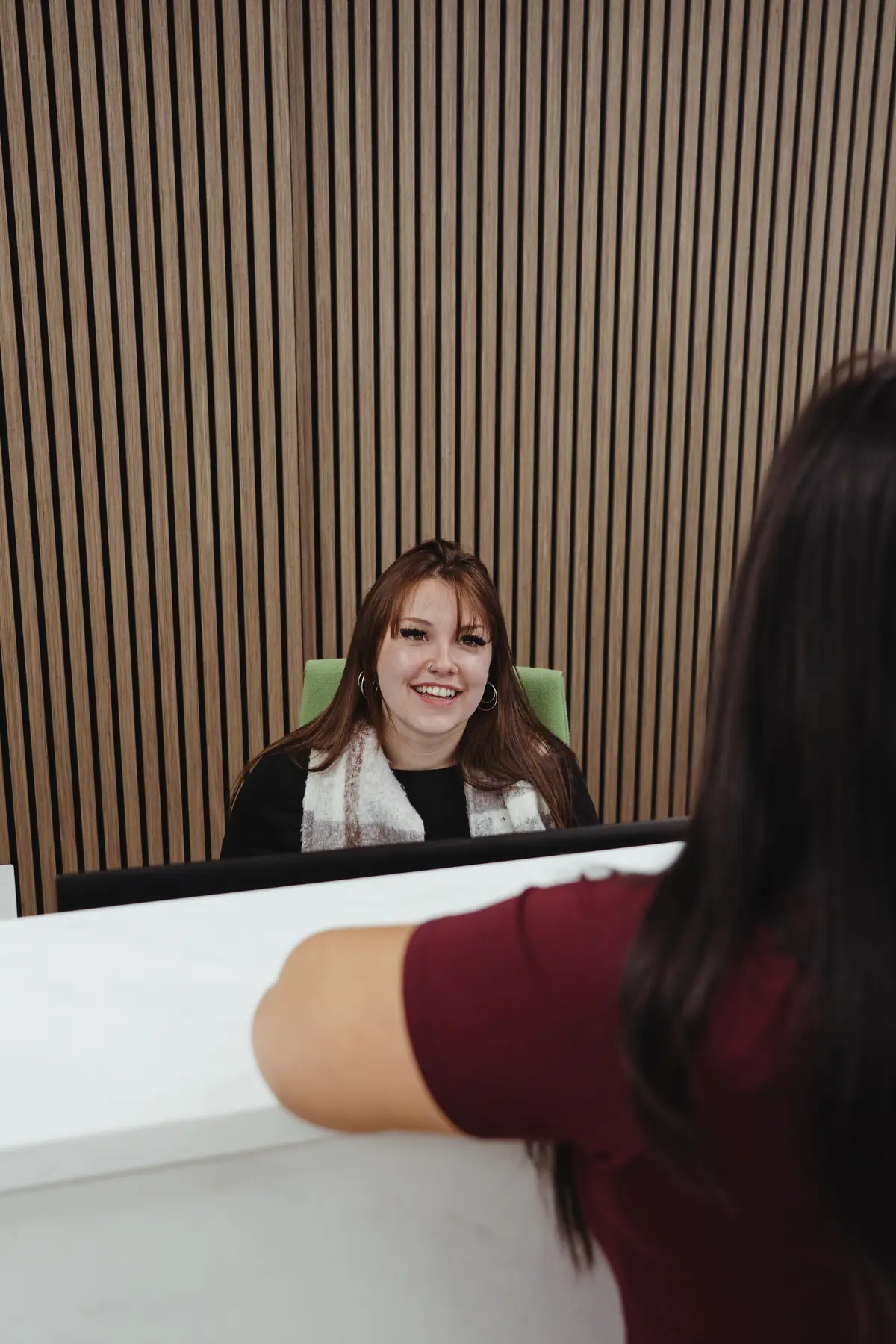 Dr. Trang Luu-Grover chatting with Ellie at the McCallum Road front desk